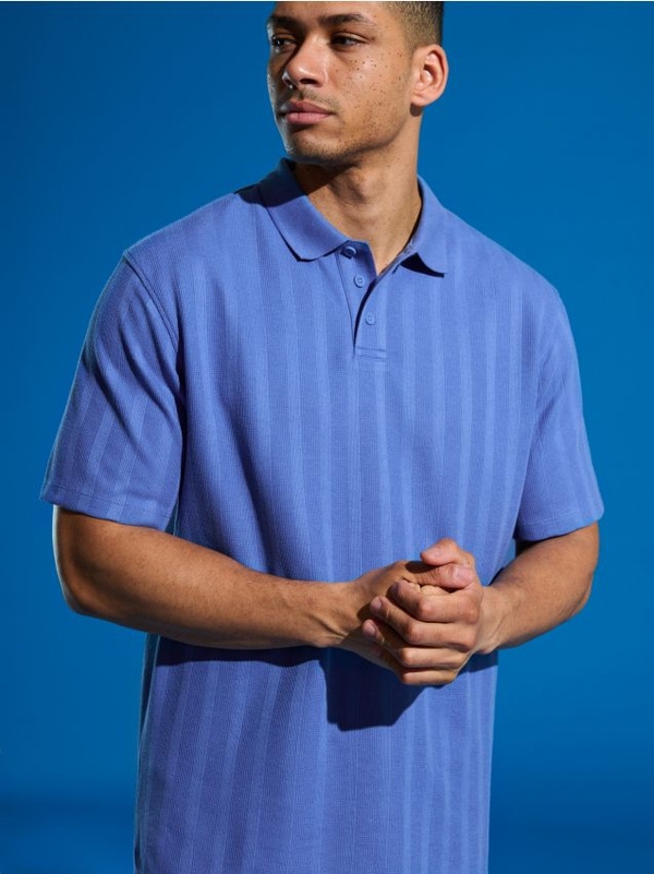 Niebieska koszulka polo Sinsay z krótkim rękawem w stylu casual z bawełny