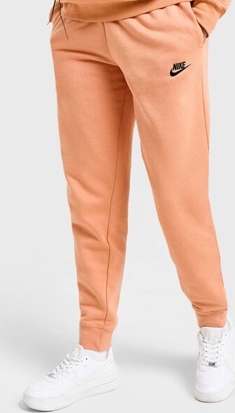 Pomarańczowe spodnie Nike z dresówki w sportowym stylu