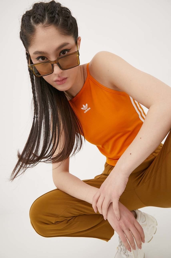 Pomarańczowy top Adidas Originals w sportowym stylu