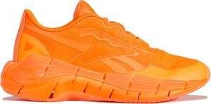 Pomarańczowe buty sportowe Reebok X Victoria Beckham sznurowane w sportowym stylu