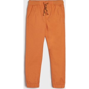 Pomarańczowe spodnie dziecięce Sinsay