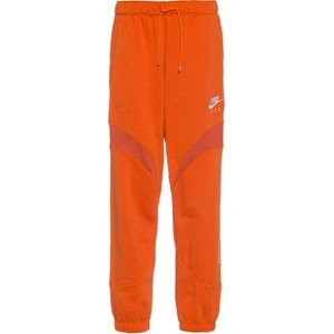 Pomarańczowe spodnie sportowe Nike z dresówki